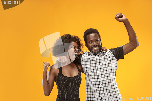 Image of Winning success couple celebrating being a winner. Dynamic energetic image of afro models