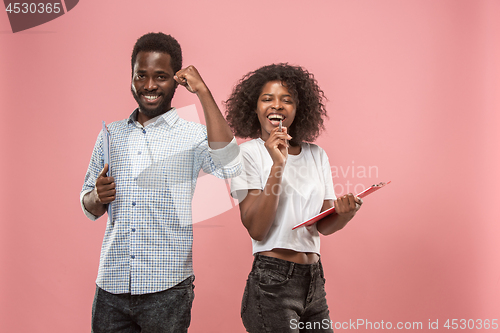 Image of Two african students with folders in t-shirts together. Stylish girl with Afro hairstyle and her boyfriend.