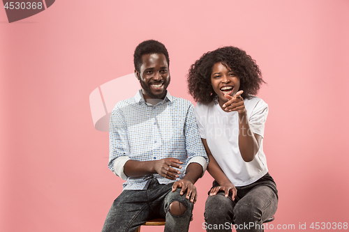Image of Couple watching sports match on tv at home, celebrating victory, successful game