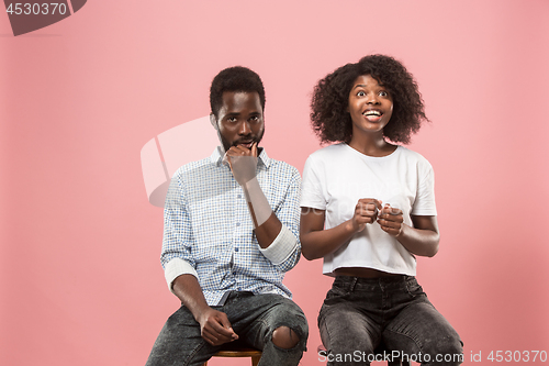 Image of Couple watching sports match on tv at home, celebrating victory, successful game