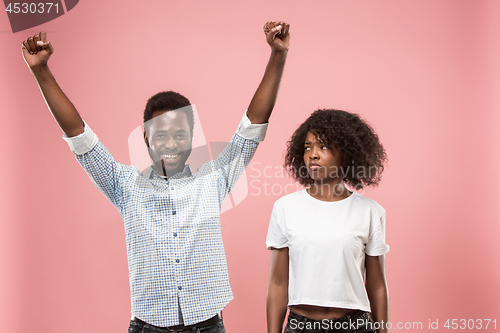 Image of Couple watching sports match on tv at home, celebrating victory, successful game