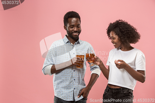 Image of The afro couple or happy young people laughing and drinking beer at studio