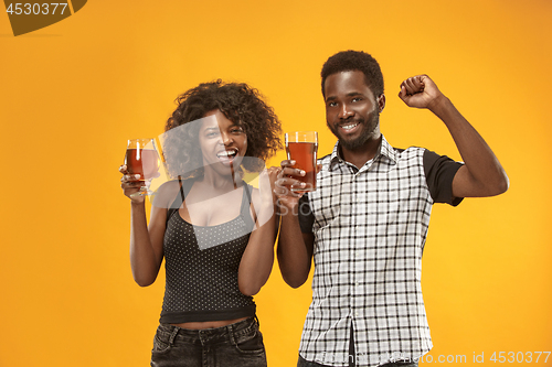 Image of The afro couple or happy young people laughing and drinking beer at studio