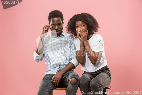 Image of Couple surprised watching sports match on tv at home, unsuccessful game