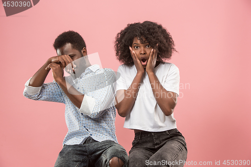 Image of Couple surprised watching sports match on tv at home, successful game