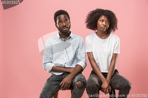 Image of Couple surprised watching sports match on tv at home, unsuccessful game