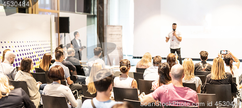 Image of Male business speaker giving a talk at business conference event.