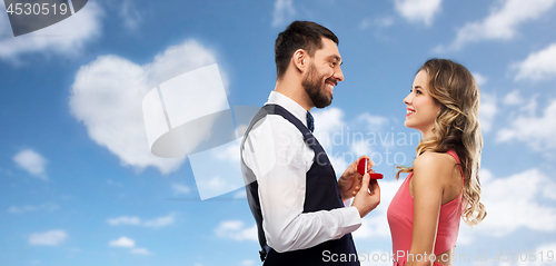 Image of man giving woman engagement ring on valentines day