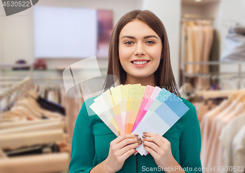 Image of woman with color swatches at clothing store