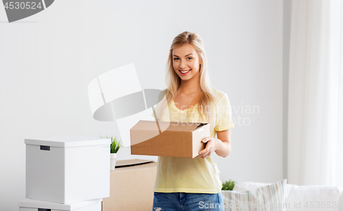 Image of happy woman with boxes moving to new home