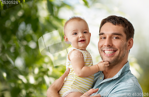 Image of happy father holding little baby daughter at home