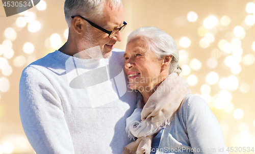 Image of happy senior couple over festive lights background