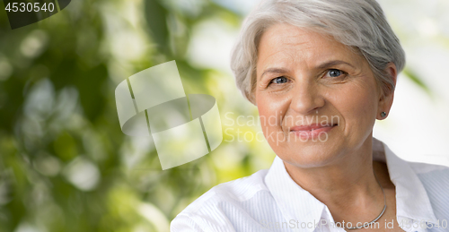 Image of portrait of senior woman over natural background