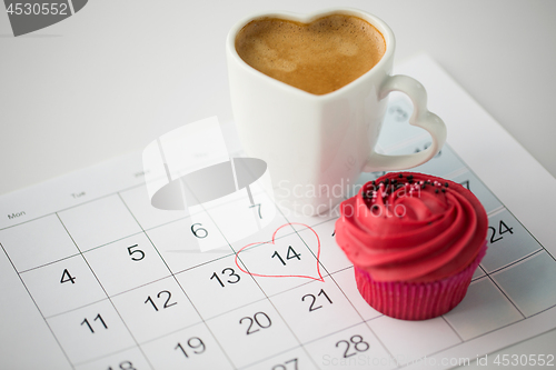 Image of close up of calendar, coffee, cupcake and heart