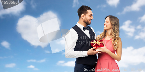 Image of happy couple with gift on valentines day