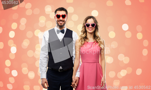 Image of happy couple in heart-shaped sunglasses