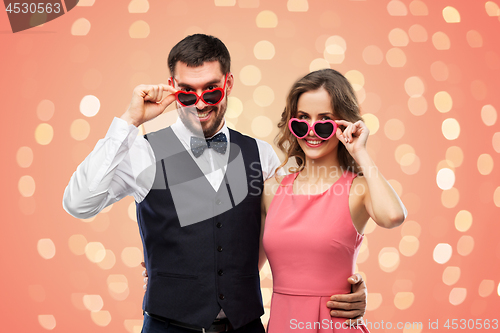 Image of happy couple in heart-shaped sunglasses