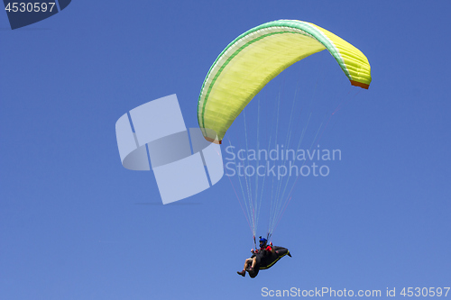 Image of Paragliding in the blue sky as background extreme sport