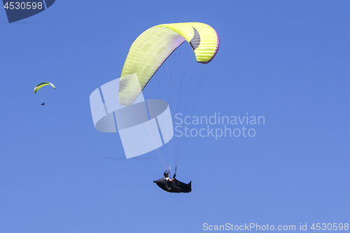 Image of Paragliding in the blue sky as background extreme sport