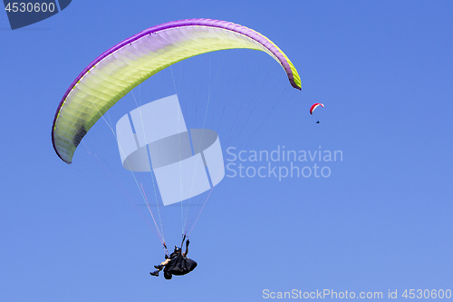 Image of Paragliding in the blue sky as background extreme sport