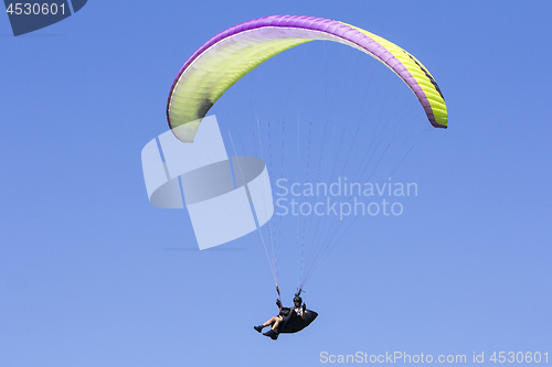 Image of Paragliding in the blue sky as background extreme sport
