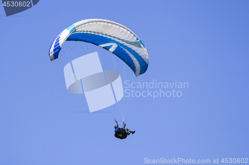 Image of Paragliding in the blue sky as background extreme sport