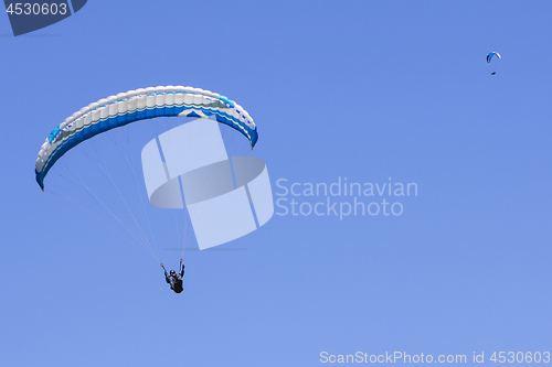 Image of Paragliding in the blue sky as background extreme sport