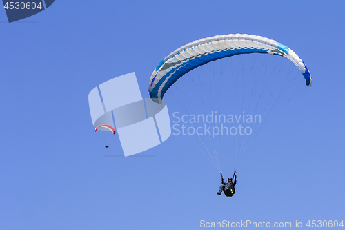 Image of Paragliding in the blue sky as background extreme sport