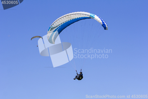 Image of Paragliding in the blue sky as background extreme sport