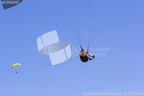 Image of Paragliding in the blue sky as background extreme sport