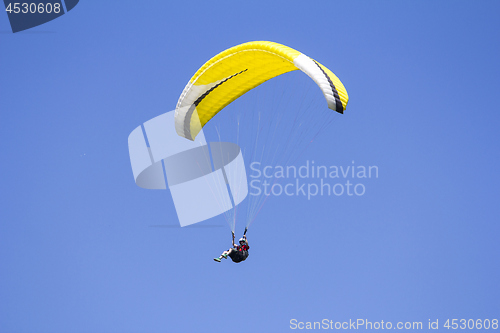 Image of Paragliding in the blue sky as background extreme sport