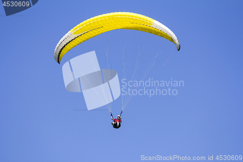 Image of Paragliding in the blue sky as background extreme sport