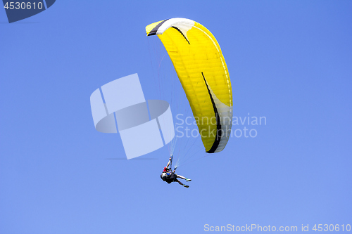 Image of Paragliding in the blue sky as background extreme sport