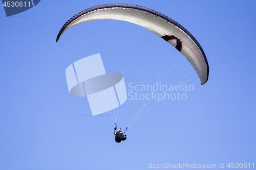 Image of Paragliding in the blue sky as background extreme sport