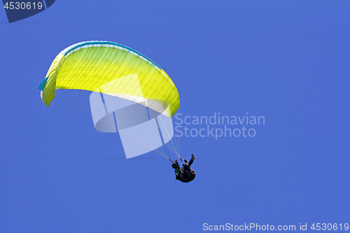 Image of Paragliding in the blue sky as background extreme sport