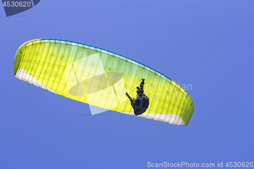 Image of Paragliding in the blue sky as background extreme sport