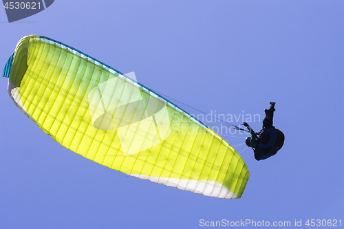 Image of Paragliding in the blue sky as background extreme sport