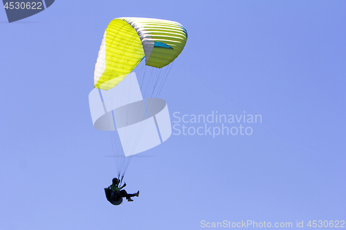 Image of Paragliding in the blue sky as background extreme sport