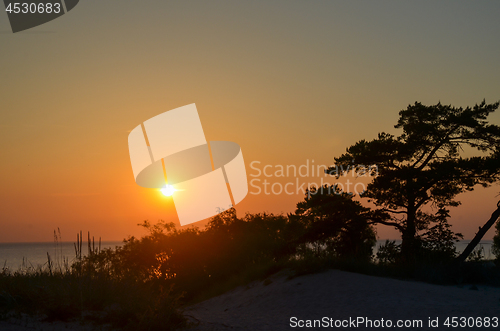 Image of Sunset with a colorful orange sky by the coast