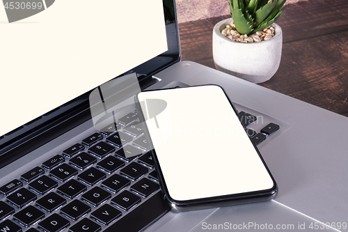 Image of Smartphone white blank screen on laptop keyboard