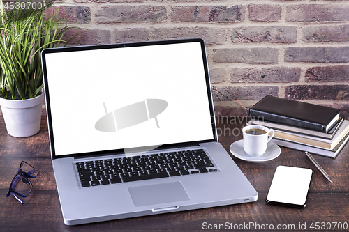 Image of Laptop notebook with blank screen and cup of coffee and notepad 