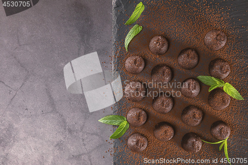 Image of Top view of chocolate truffles powdered with cocoa