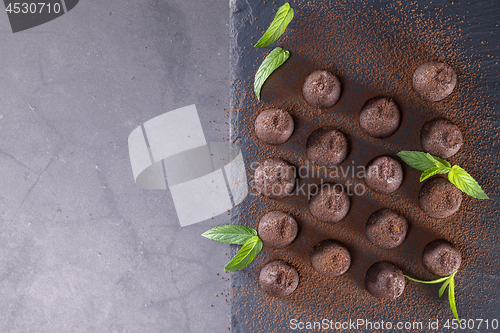 Image of Top view of chocolate truffles powdered with cocoa