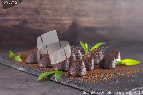 Image of Homemade chocolate truffles with mint sprinkled with cocoa powde