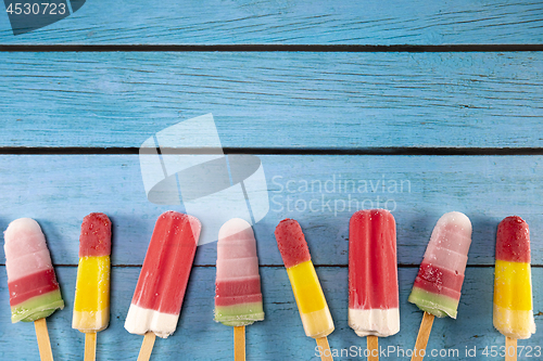 Image of Ice cream stick placed on a blue vintage wooden