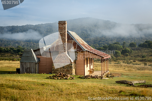 Image of Old country homestead as the morning fog lifts