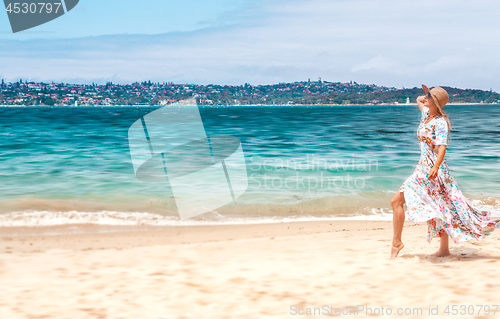 Image of Woman in flowing dress on beach in Sydney Australia