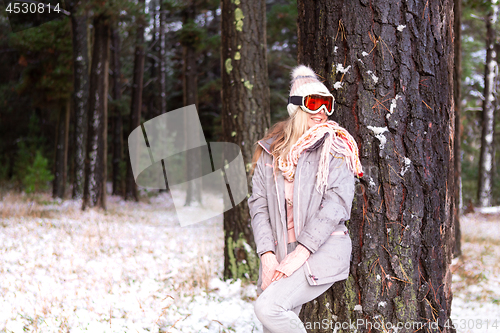 Image of Woman in a snowy woodland of pine trees