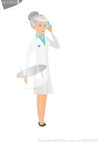 Image of Senior caucasian doctor talking on a mobile phone.