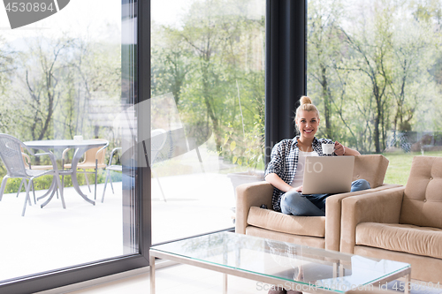 Image of woman drinking coffee enjoying relaxing lifestyle